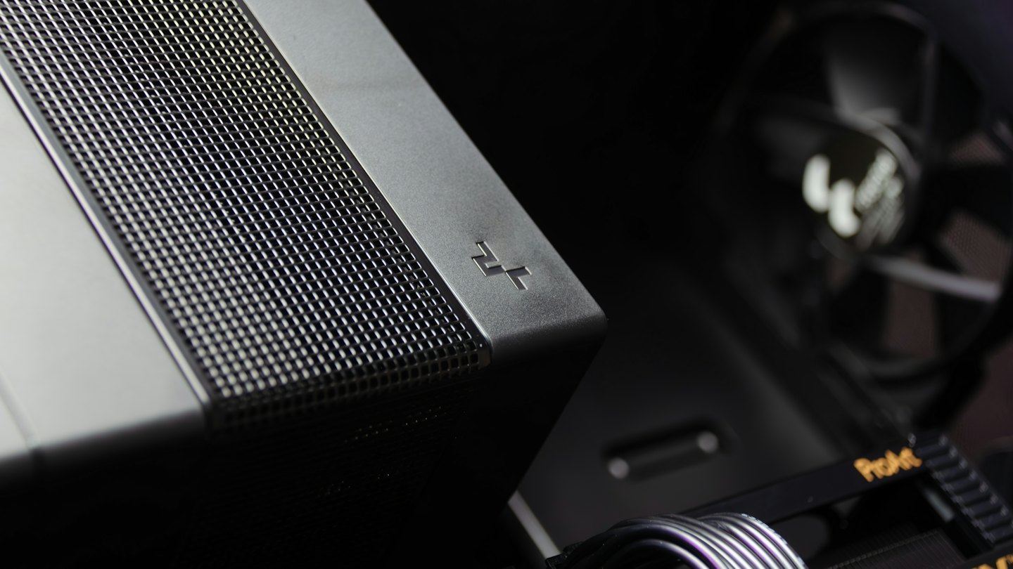 Dark grey computer components with organized cables and metal surfaces.