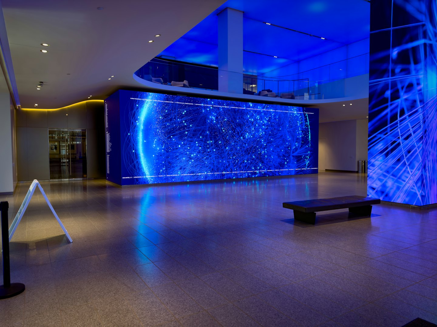 Modern corporate lobby with an abstract digital display wall.
