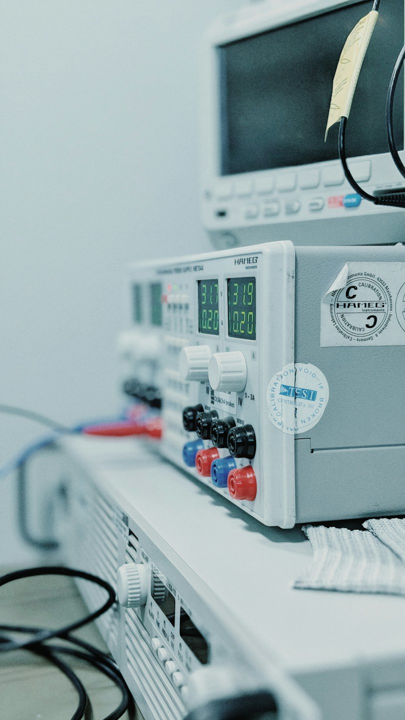 HAMEG power supply unit on a laboratory workbench with digital readings.